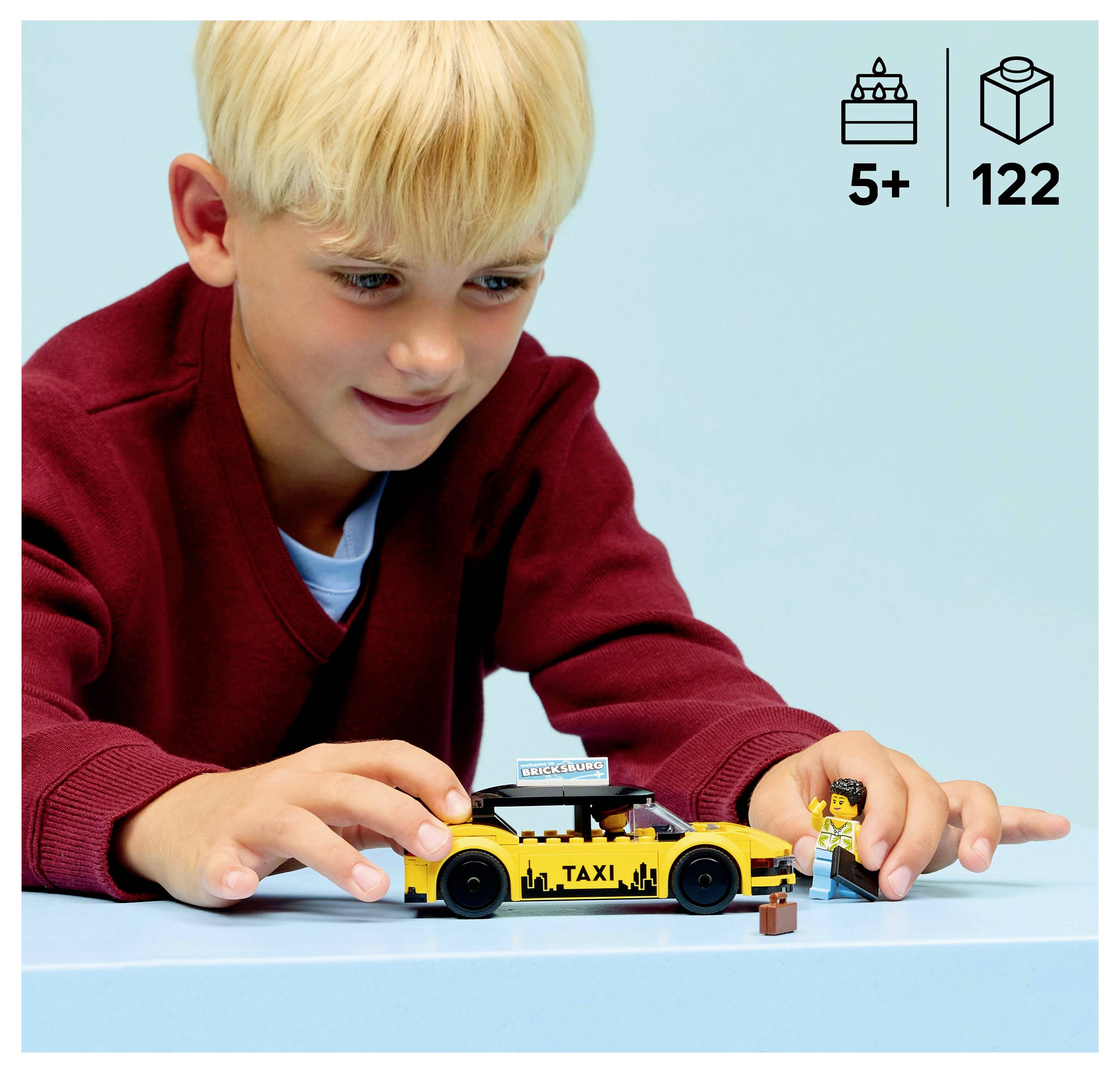 Un jeune enfant joue avec un taxi jouet jaune et une figurine sur une surface bleue. Des icônes dans le coin indiquent l'âge 5+ et 122 pièces.