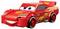 Une voiture miniature ressemblant à une voiture de course, avec une carrosserie rouge vif, des yeux sur le pare-brise, des autocollants, et le numéro '95' sur le côté.