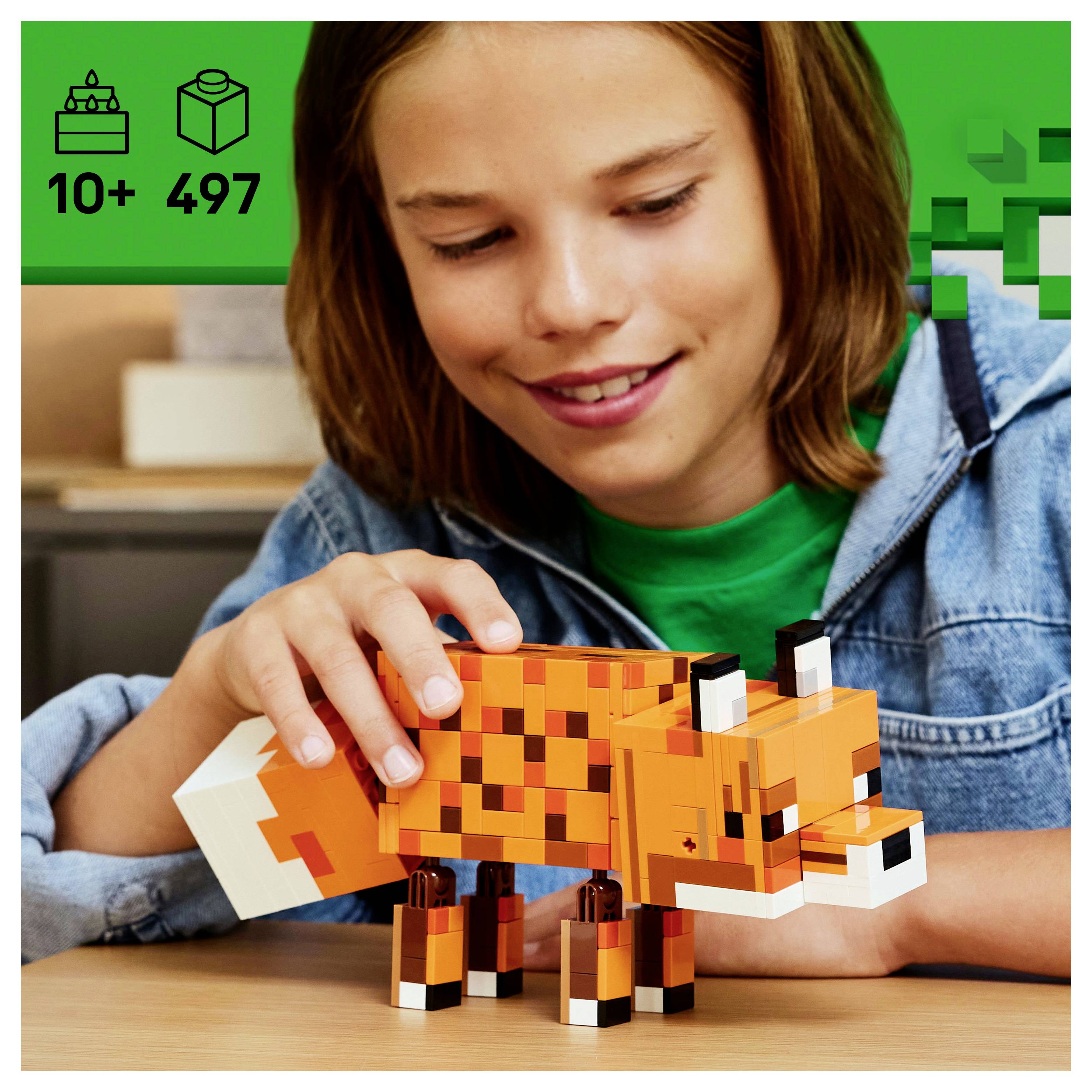 Un enfant construit un jouet renard orange et cubique. L'emballage indique « 10+ 497 », précisant l'âge et le nombre de pièces. L'arrière-plan présente un motif vert.