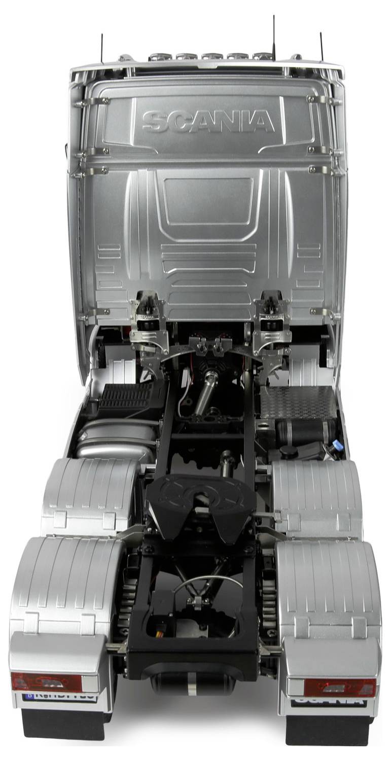 Une cabine de camion-jouet argentée vue de l'arrière, montrant des composants détaillés et des marques. Aucune remorque n'est attachée.