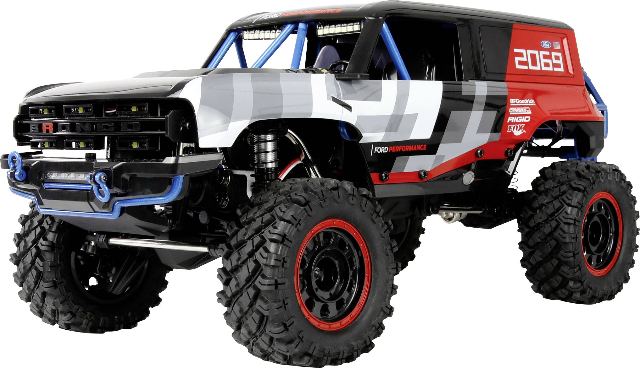 Un camion télécommandé (RC) tout-terrain de grande taille, doté de pneus surdimensionnés et d'une carrosserie blanche, noire et rouge, mettant l'accent sur un design robuste.