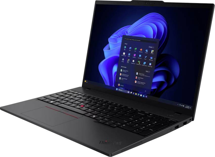 Un ordinateur portable ouvert sur une table affiche le bureau Windows avec la barre des tâches au premier plan.