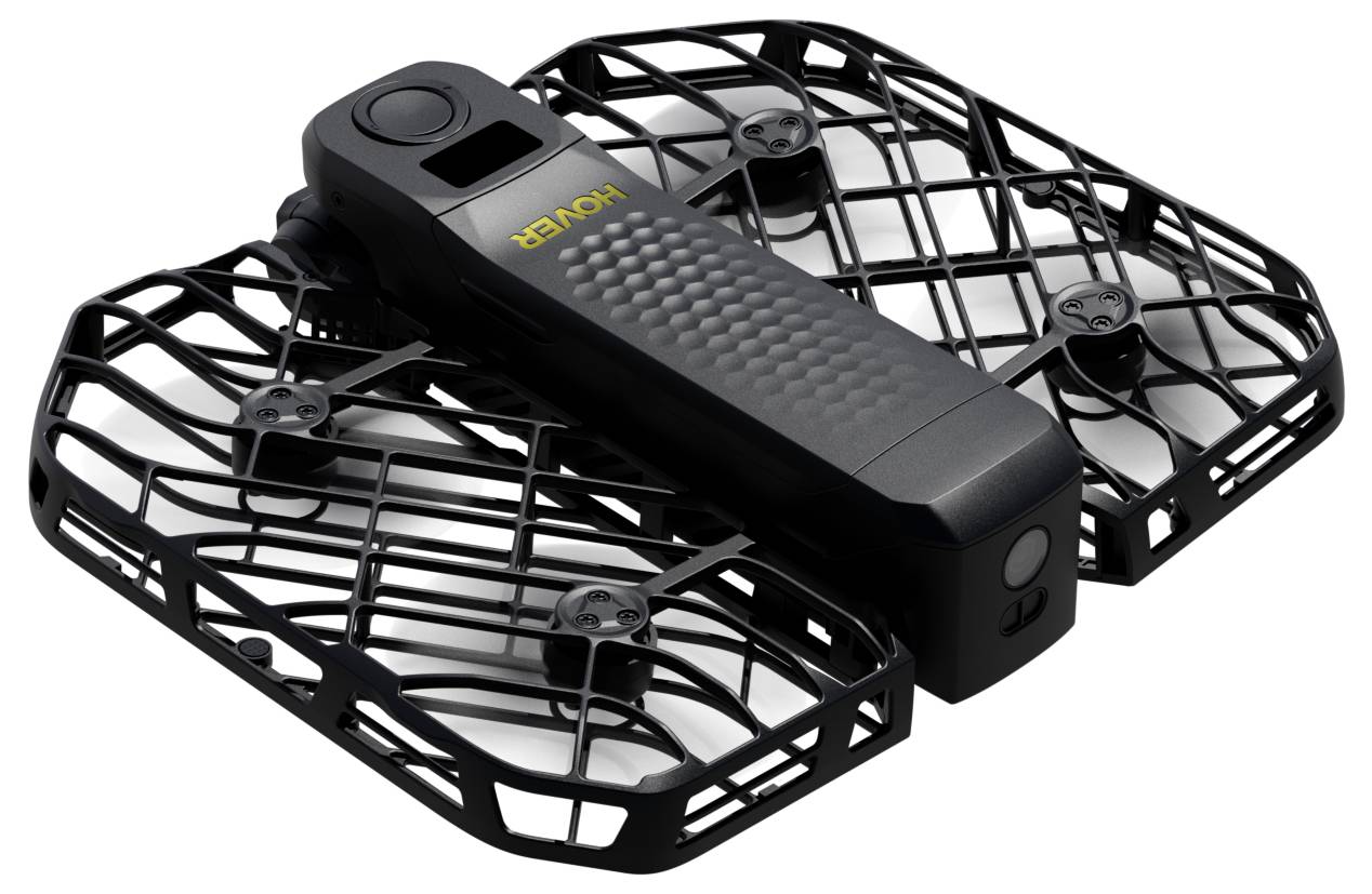 Un drone noir pliable avec des cages de protection, arborant le mot « Hover » sur son corps. Conçu pour un vol intérieur en toute sécurité.