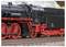 Une locomotive à vapeur miniature avec un corps noir et des roues rouges exposée, mettant en valeur les détails intriqués de son moteur et de ses roues.