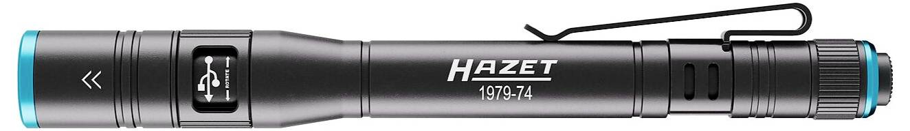 Un stylo-lampe de poche noir Hazet, modèle 1979-2L, avec un clip de ceinture et des touches turquoise, présenté horizontalement.