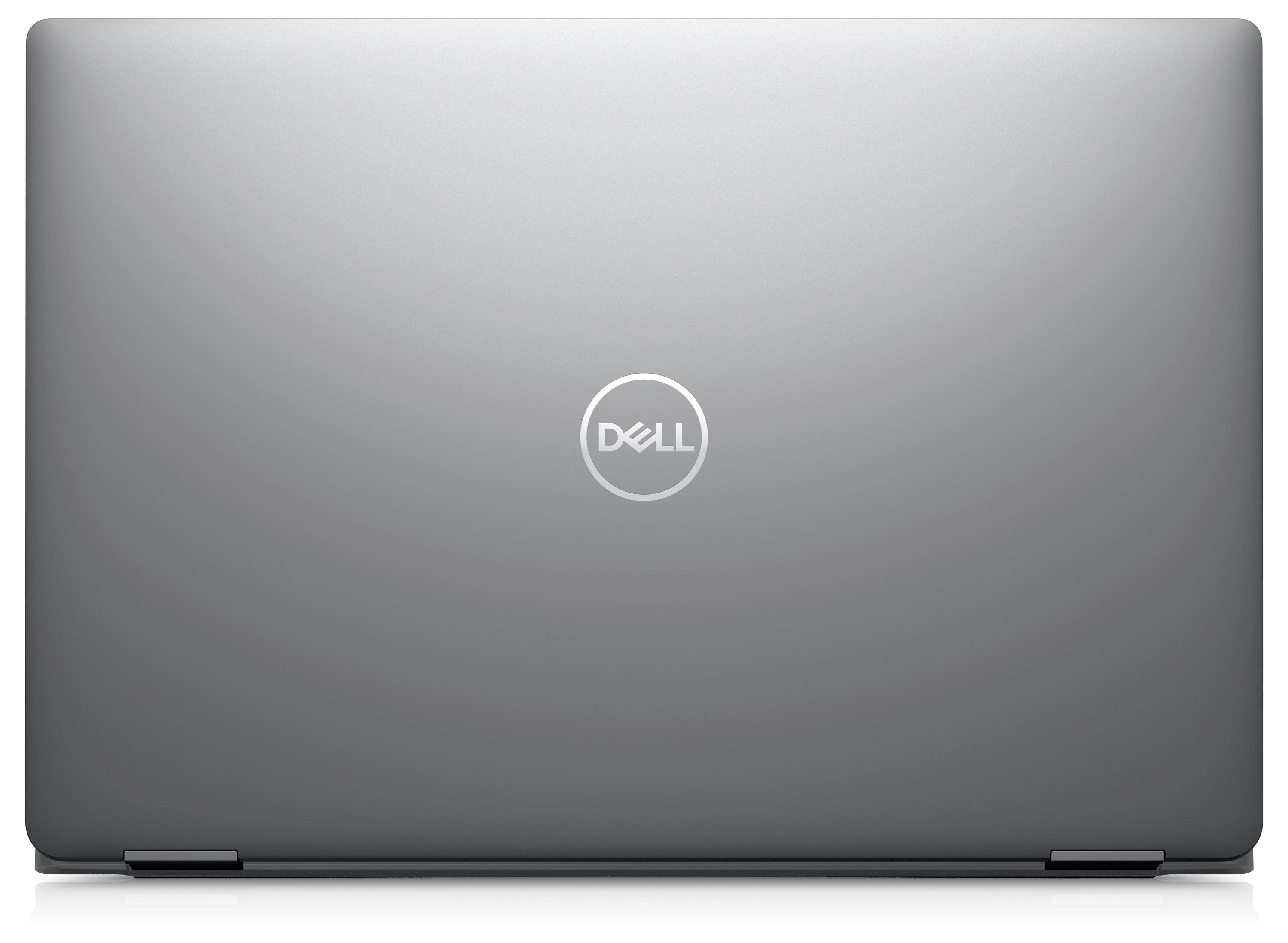 Un ordinateur portable Dell fermé affichant le logo de l'entreprise sur son couvercle argenté.