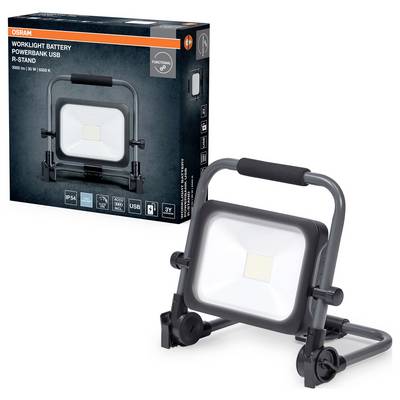 Projecteur LED portable avec poignée et support réglable placé devant son emballage. Le carton affiche 'Worklight Battery Powerbank USB R-Stand'.