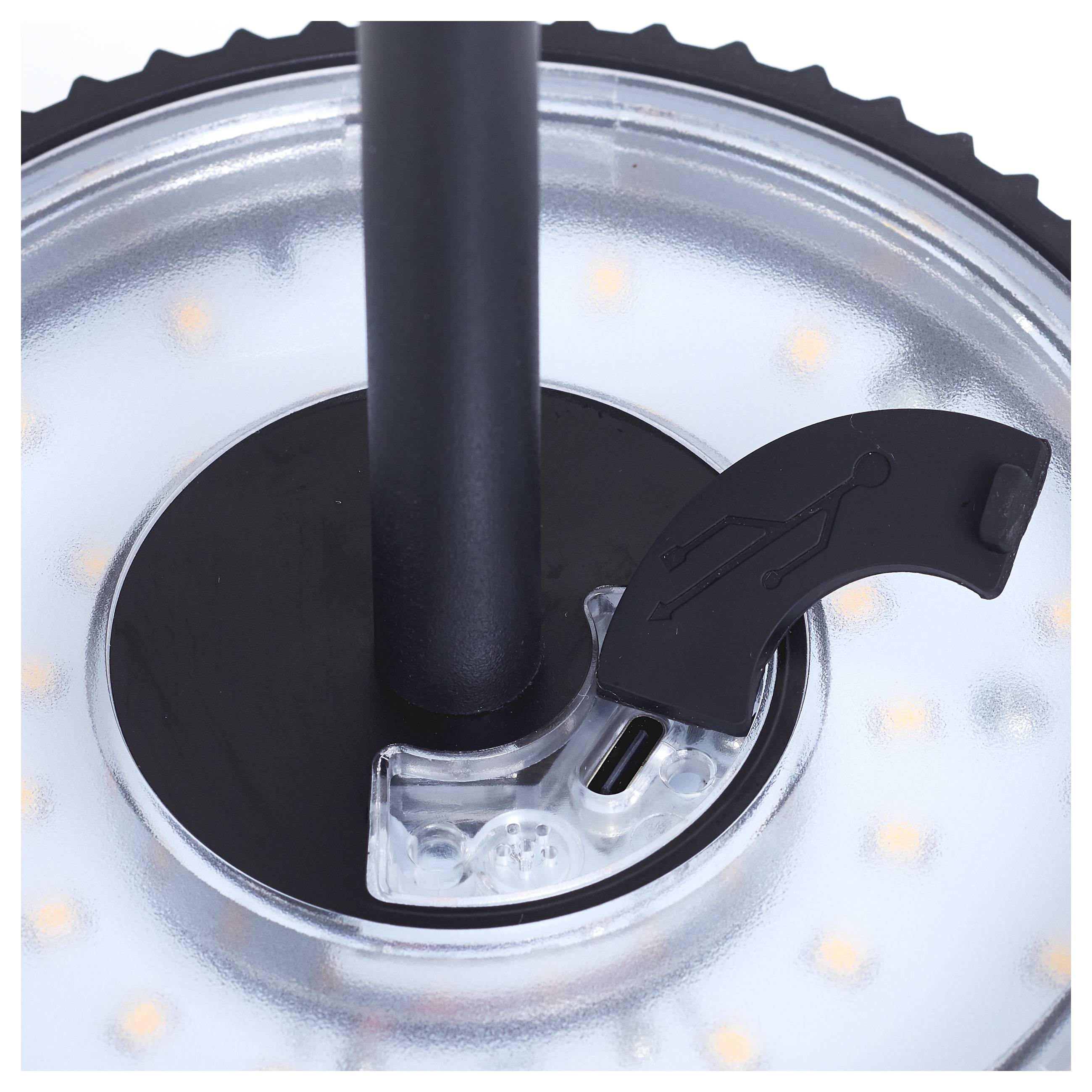 Gros plan sur un anneau lumineux LED circulaire avec une tige centrale noire et une petite poignée noire portant une icône de silhouette humaine.