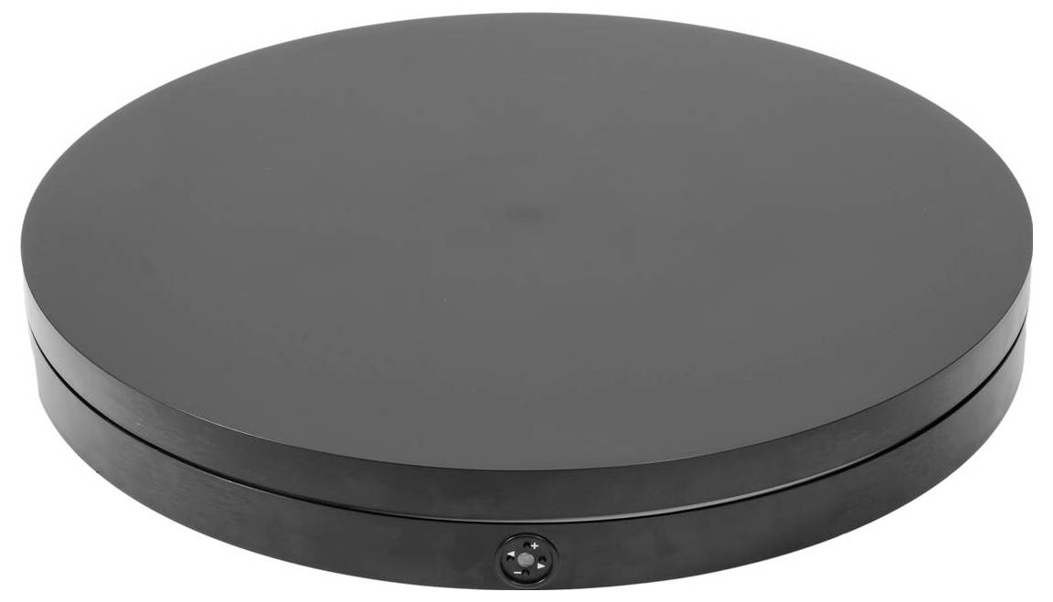 Une plateforme de platine ronde, plate, noire avec une surface lisse, conçue pour faire tourner des objets.