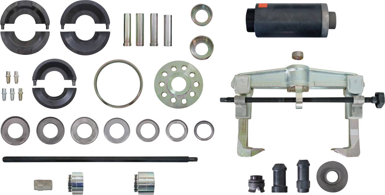« Assortiment d'outils automobiles disposés, comprenant des poulies, des goupilles, des bagues et un extracteur, utilisés pour les tâches d'entretien et de réparation des véhicules. »