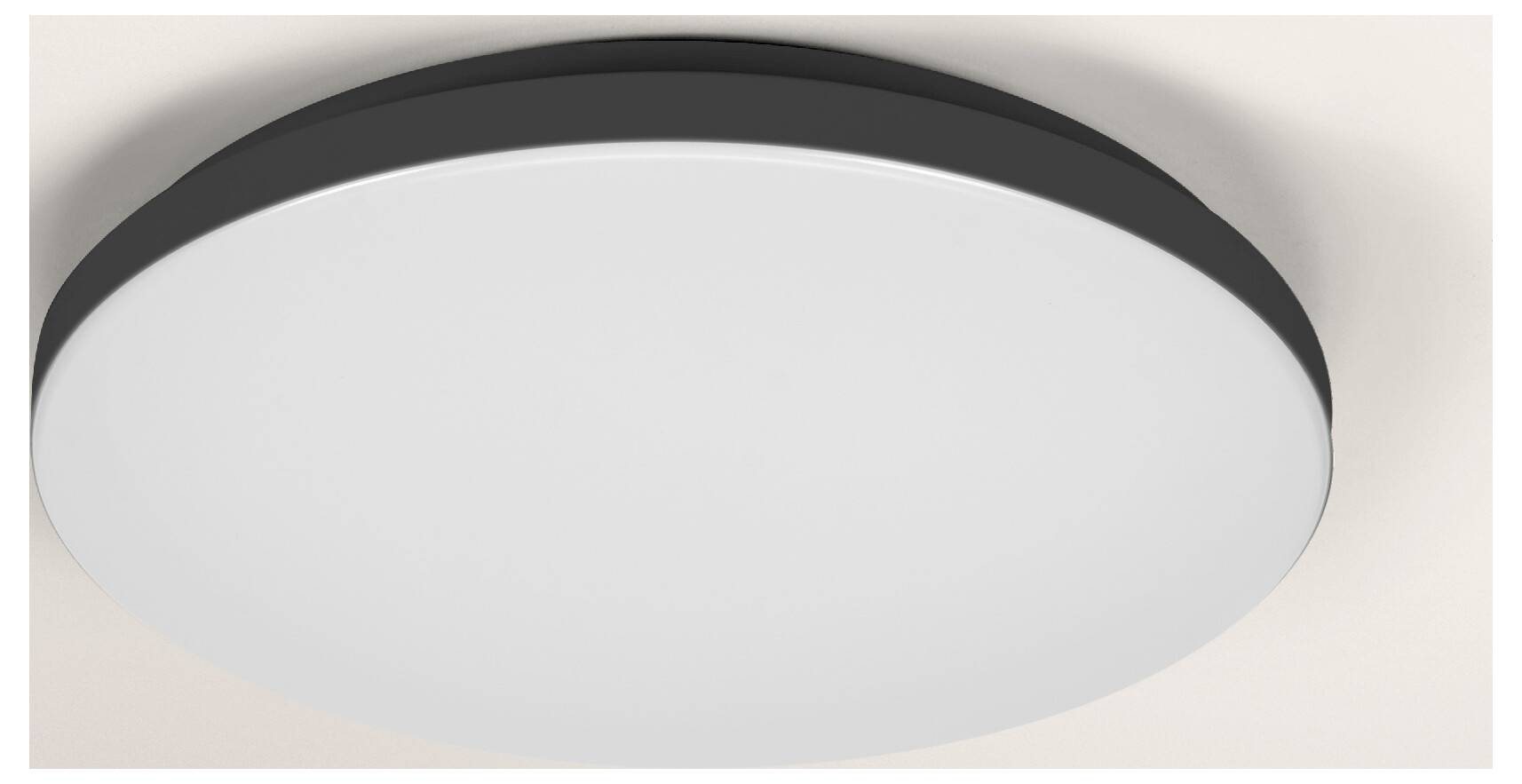 Une longue barre lumineuse LED cylindrique avec un boîtier noir, montée horizontalement sur un mur de couleur claire.
