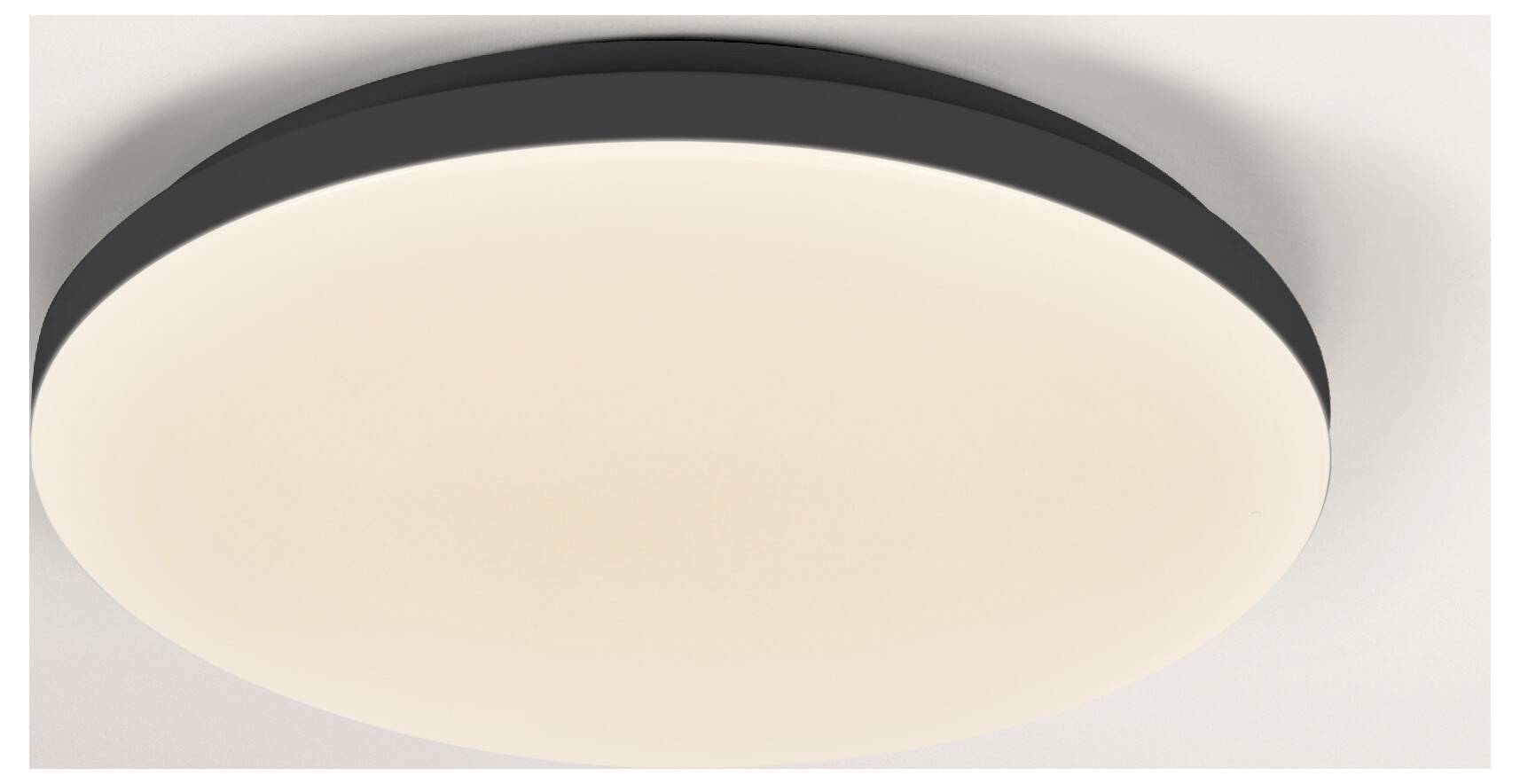 Un luminaire de plafond minimaliste et rond avec une bordure noire et une douce lueur blanche, monté sur un plafond blanc.