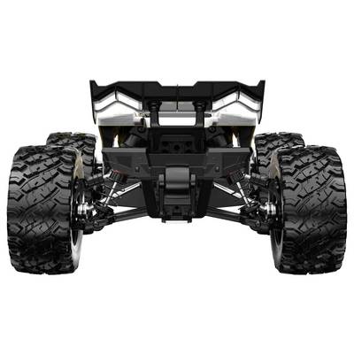 Vue arrière d'un châssis de véhicule tout-terrain avec des pneus à crampons surdimensionnés, des bras de suspension et un groupe motopropulseur central sur un fond blanc.