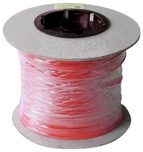 Une bobine de filament rouge et transparent enroulé soigneusement à des fins d'impression 3D.