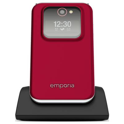 Un téléphone à clapet rouge avec un écran d'horloge numérique affichant « 12:30 », sur un socle de recharge noir. Le nom de marque « emporia » est visible sur le téléphone.