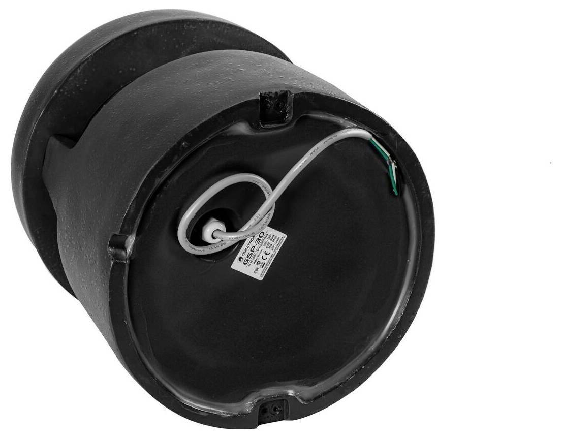 Une base cylindrique noire avec un cordon et une étiquette fixés sur le côté inférieur, indiquant les détails de connexion ou de configuration.