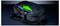Un sac à dos noir avec 'RAZER' écrit sur le dessus, partiellement ouvert révélant un intérieur vert vif. Le design comprend des poches en filet et des accents verts.