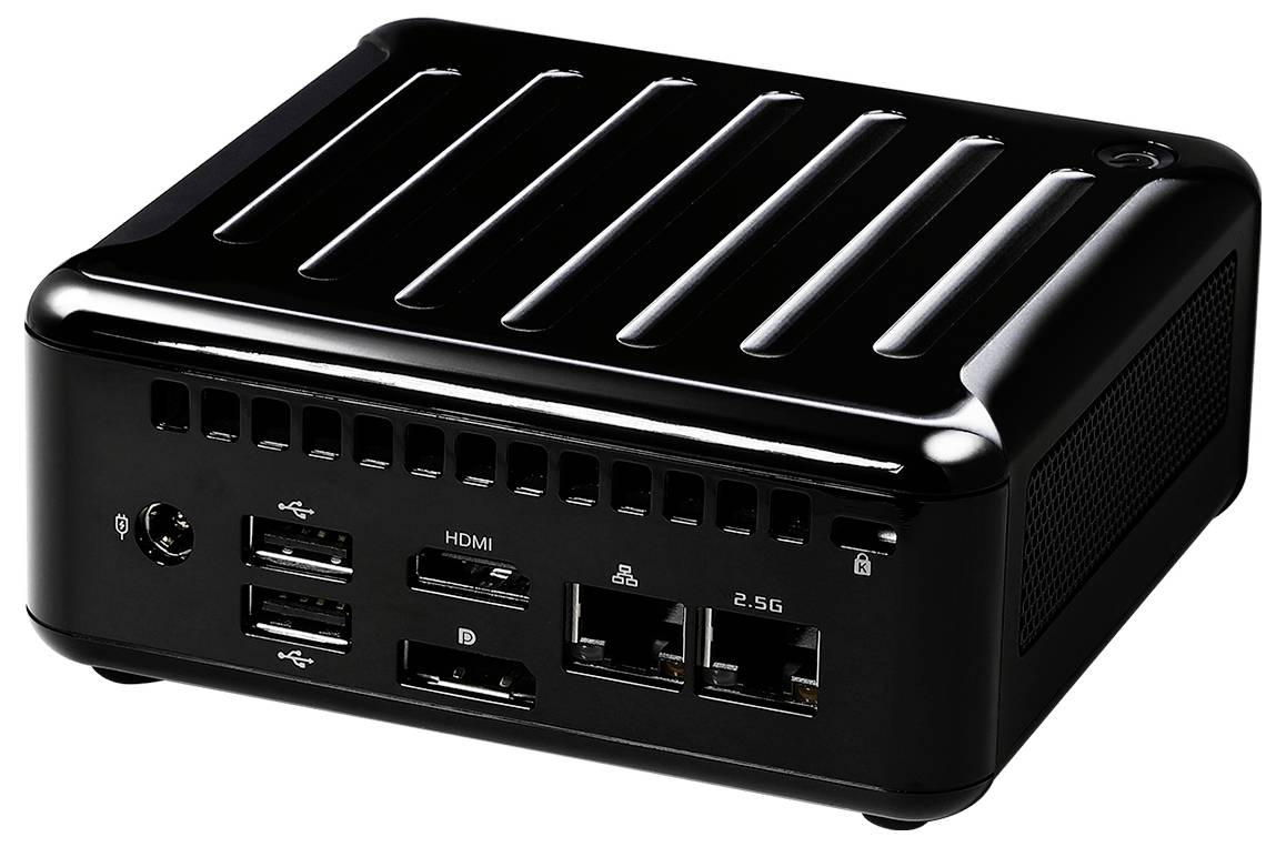 Un petit mini PC noir avec plusieurs ports USB, HDMI, DisplayPort, Ethernet et port audio visibles sur le panneau avant.