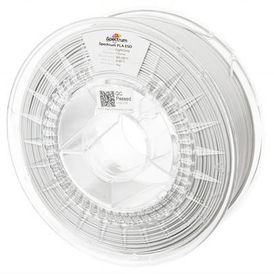 Bobine de filament transparent pour imprimante 3D portant l'étiquette « Spectrum PLA ESD », avec un autocollant « QC Passed ».