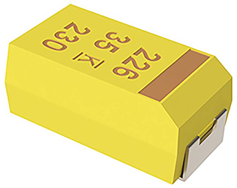 Un composant électronique jaune, possiblement un condensateur au tantale, avec des marquages rouges et un connecteur métallique sur un côté.