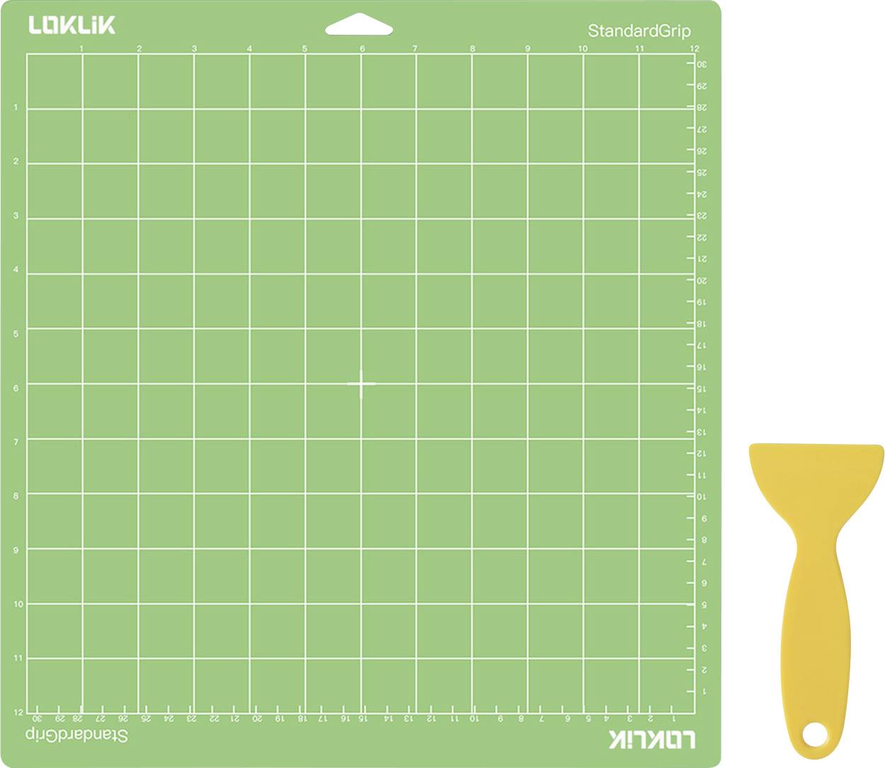 Un tapis de découpe vert avec un motif de grille étiqueté « LOKLIK StandardGrip » à côté d'une raclette en plastique jaune utilisée pour les projets d'artisanat ou de bricolage.