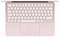Un ordinateur portable rose vu de dessus, montrant un clavier de disposition compacte avec un grand pavé tactile en dessous.