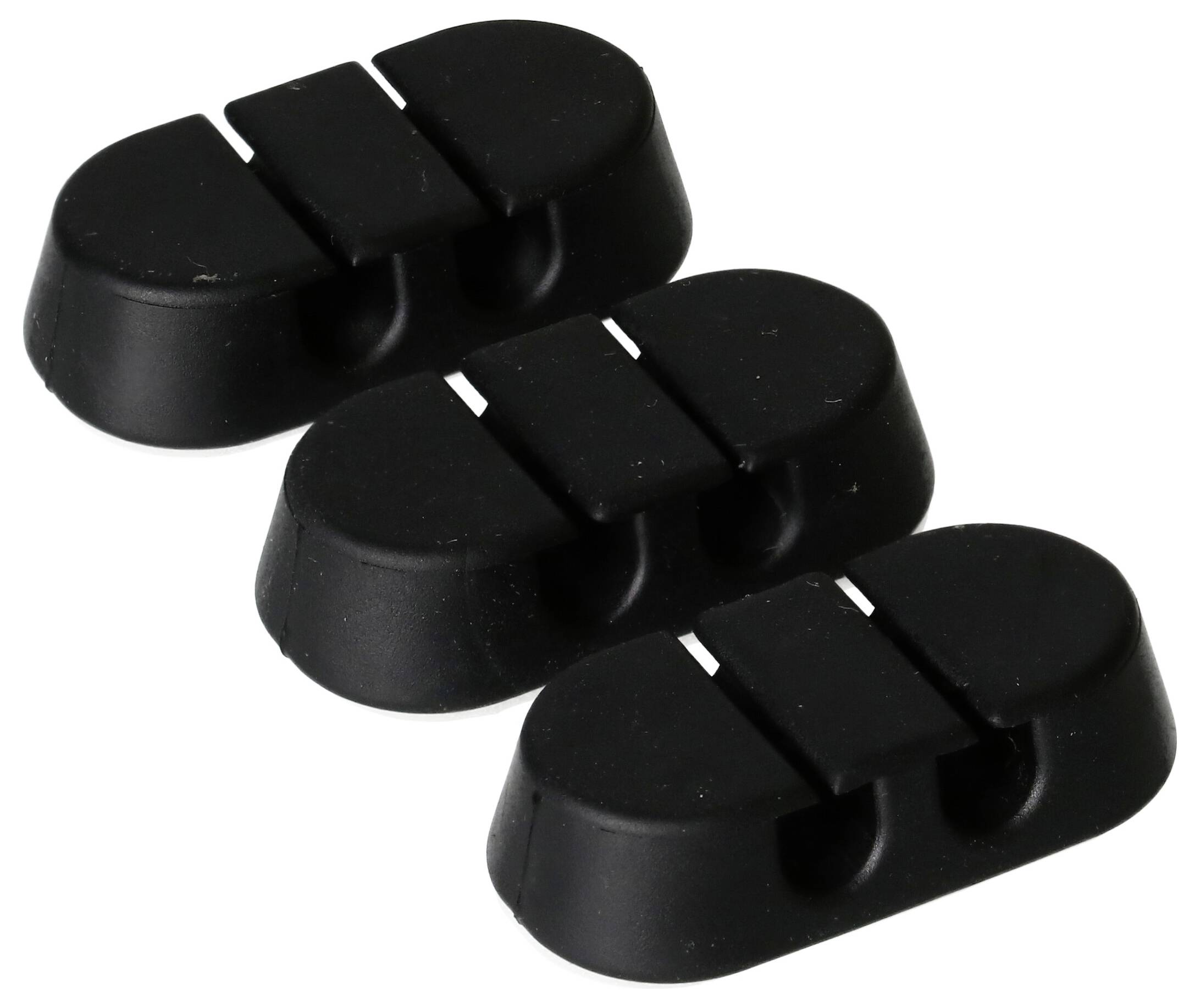 Trois pinces de câble en caoutchouc noir alignées en rangée, conçues pour organiser et fixer les câbles sur un bureau ou une surface.