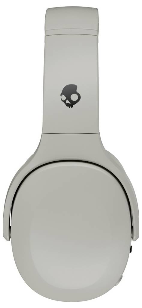 Casque audio gris supra-auriculaire présentant un logo de crâne sur le serre-tête.