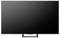 Un téléviseur à écran plat avec une bordure fine, affichant un écran noir vierge, posé sur un support simple au design minimaliste.