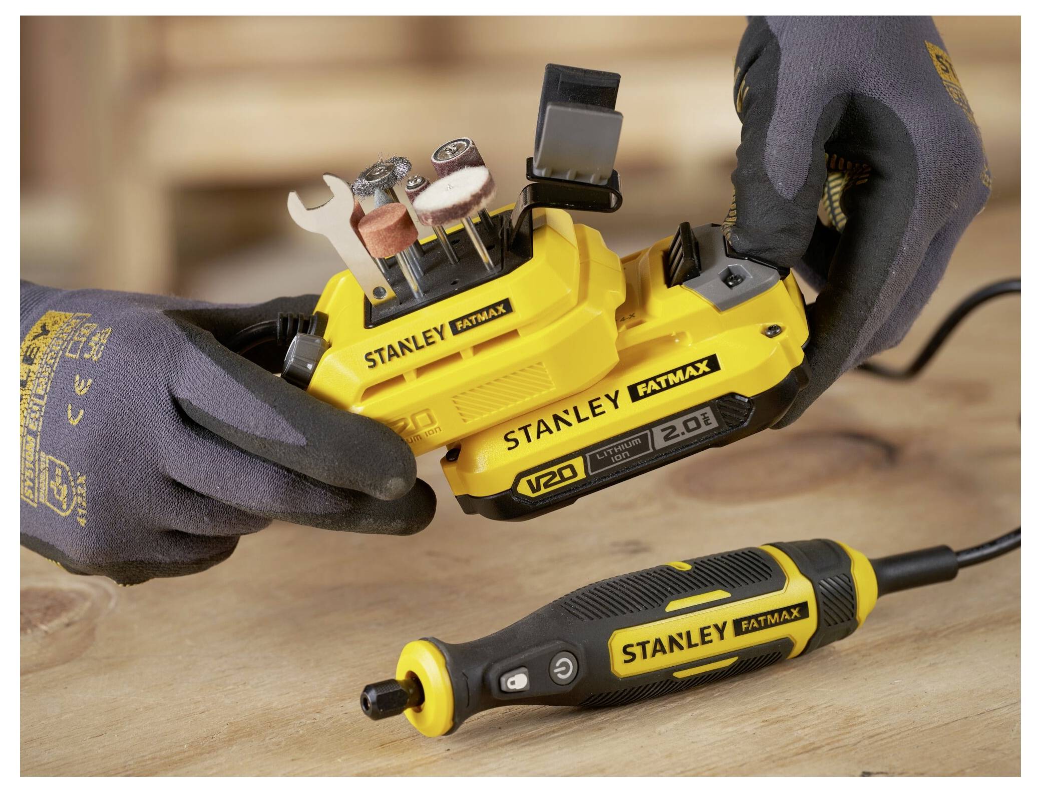 Une perceuse sans fil jaune et noire avec un cordon enroulé repose sur une base de chargement assortie. Le nom de marque « STANLEY » est visible sur la base.