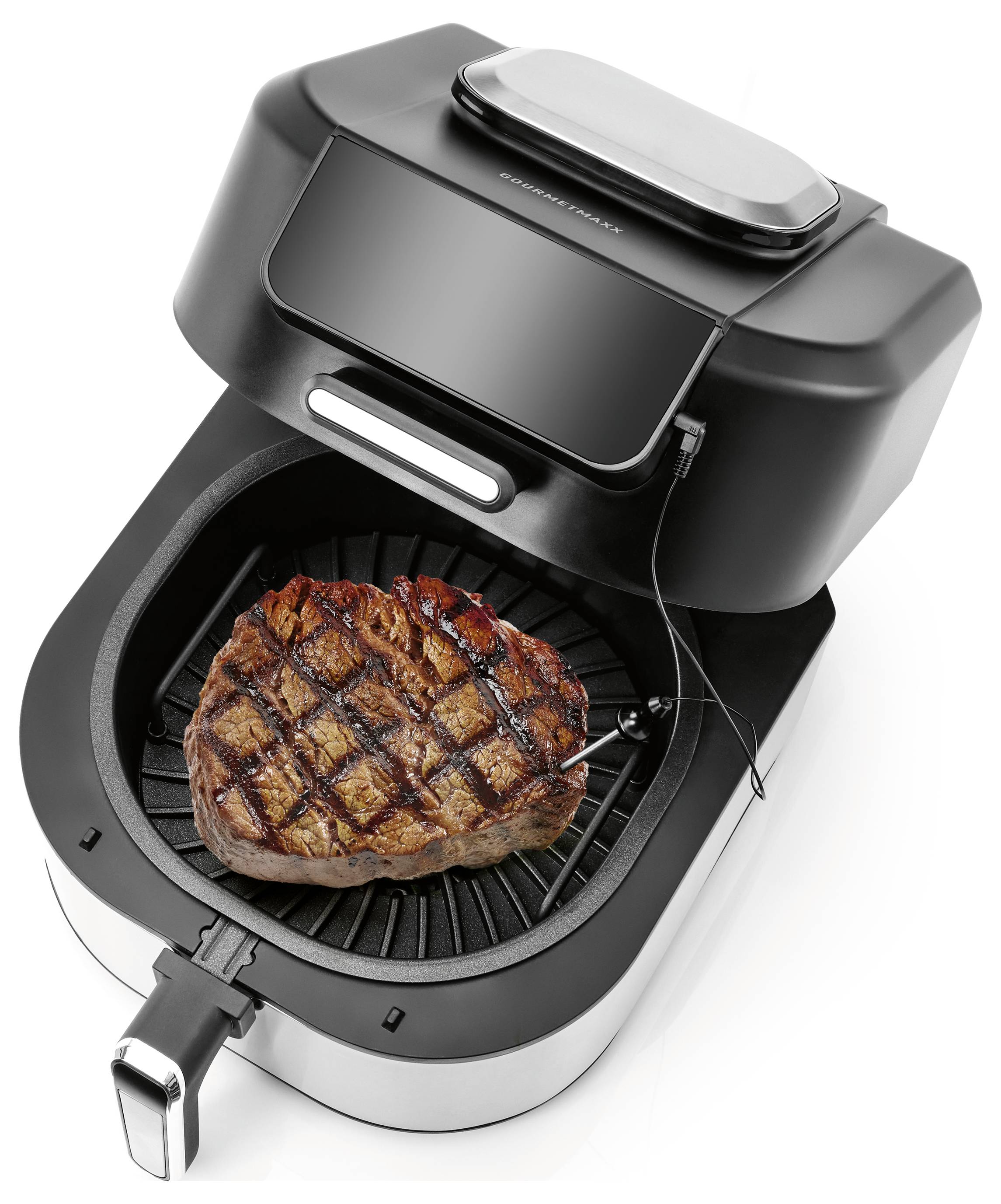 Un friteuse à air avec un steak à l'intérieur, montrant des marques de grill, connectée à une sonde de température, démontrant les fonctionnalités de cuisson.