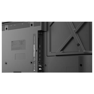 Arrière d'un téléviseur à écran plat montrant le panneau de montage et les ports d'entrée, y compris les connexions HDMI et antenne, sur un boîtier gris foncé.