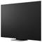 Grand téléviseur/moniteur à écran plat noir montré sous un angle sur un support, isolé sur fond blanc.