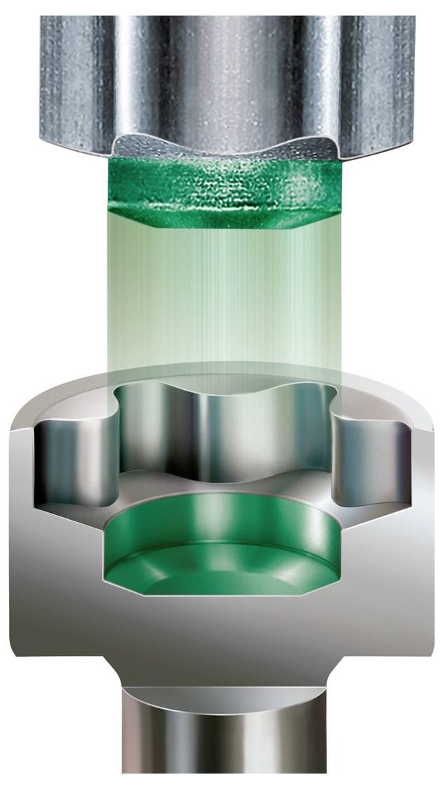 Coupe transversale d'une presse formant une pièce métallique, avec un matériau vert étant comprimé dans une cavité de matrice.