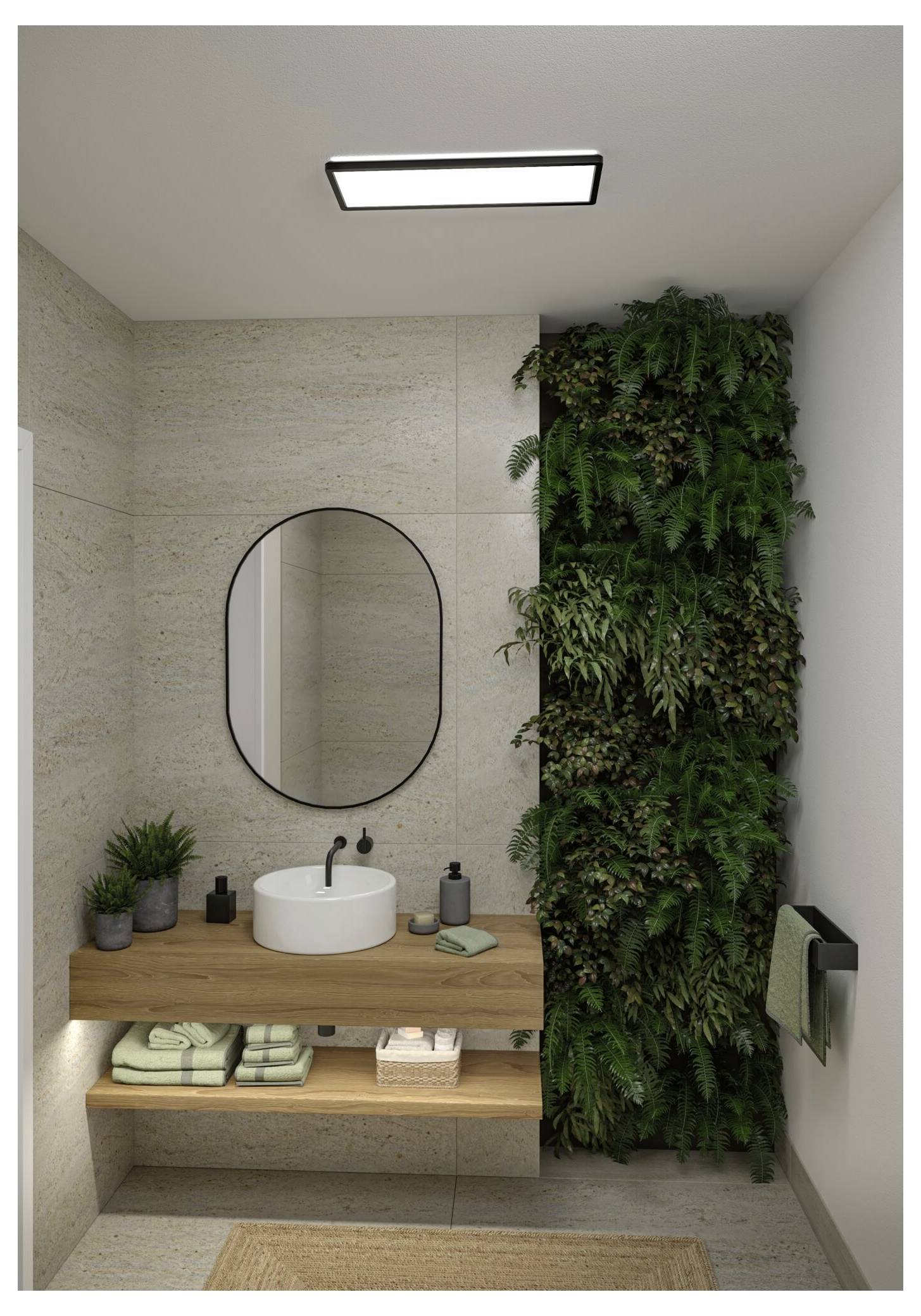 Salle de bain moderne avec un meuble-lavabo flottant en bois, un miroir ovale, un lavabo blanc et un luxuriant mur végétal vertical à côté du lavabo.