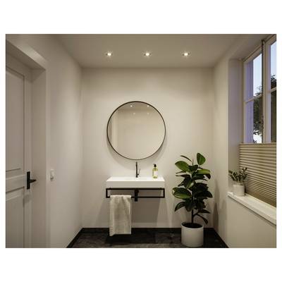 Salle de bains minimaliste moderne avec lavabo mural, miroir rond, serviette, plante en pot et fenêtre avec stores.
