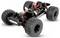 Châssis de buggy tout-terrain télécommandé avec quatre grands pneus à crampons et suspension apparente, présenté sur un fond blanc.