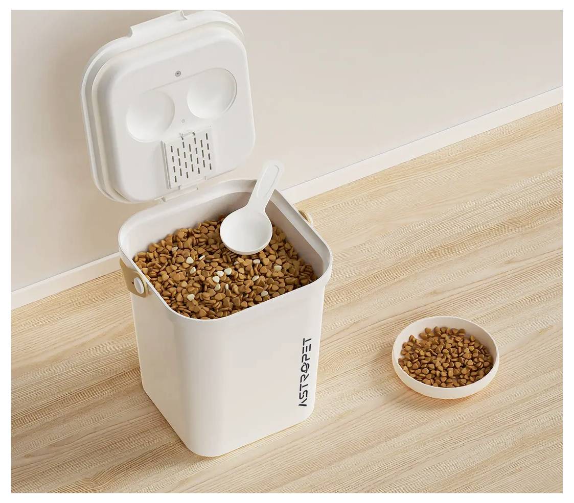 Récipient de nourriture pour animaux de compagnie ouvert avec une cuillère à côté d'un petit bol sur un plancher en bois.