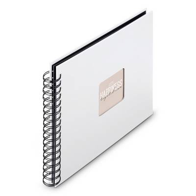 Carnet à spirale blanche avec une étiquette rose centrée portant l'inscription « BONHEUR » sur la couverture.