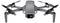 Drone quadricoptère gris avec quatre hélices et caméra frontale, présenté sur un fond blanc.