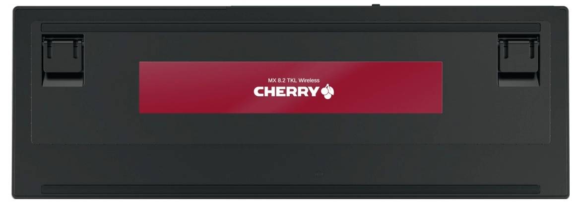 Clavier CHERRY sans fil noir, montré de l'arrière avec une bande logo CHERRY rouge et des pieds/loquets arrière intégrés.