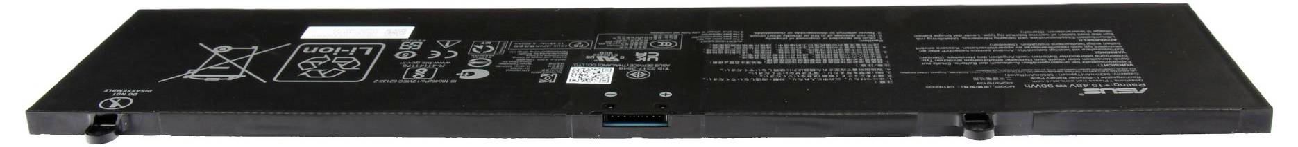 Vue de dessus d'un long appareil électronique noir, probablement un pack de batterie, avec des étiquettes d'avertissement imprimées et des ports de connecteur sur le bord avant.