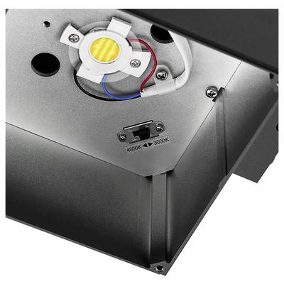 Gros plan de l'intérieur d'un luminaire, montrant un module LED allumé et un commutateur de température de couleur étiqueté « 4000K » et « 3000K ».