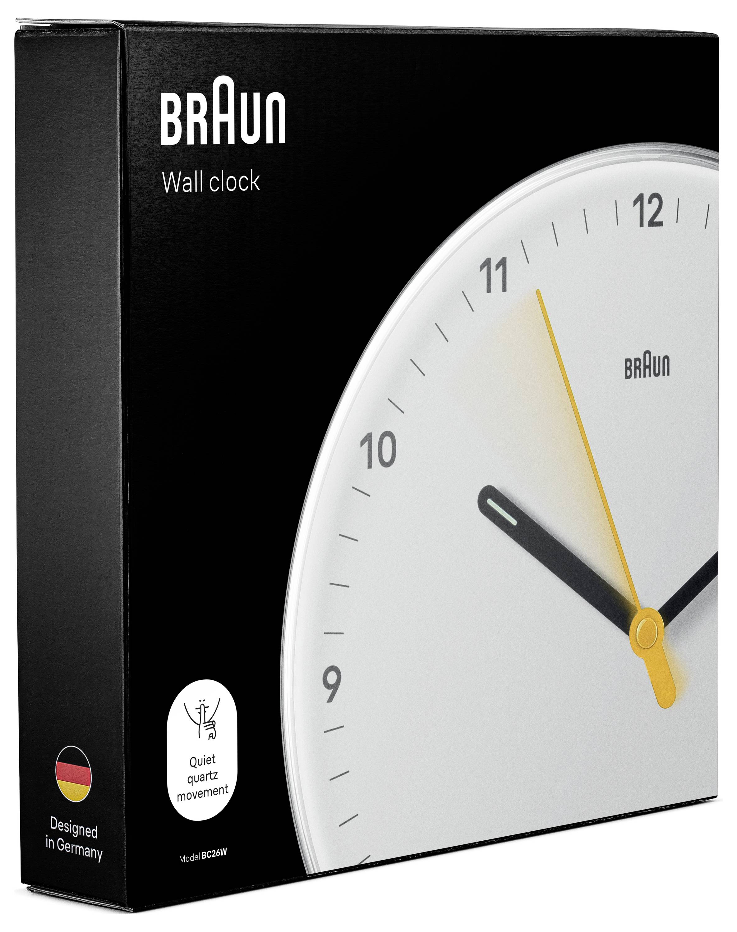 Emballage de l'horloge murale Braun avec une boîte noire et un cadran de montre analogique blanc affichant des aiguilles minimalistes.