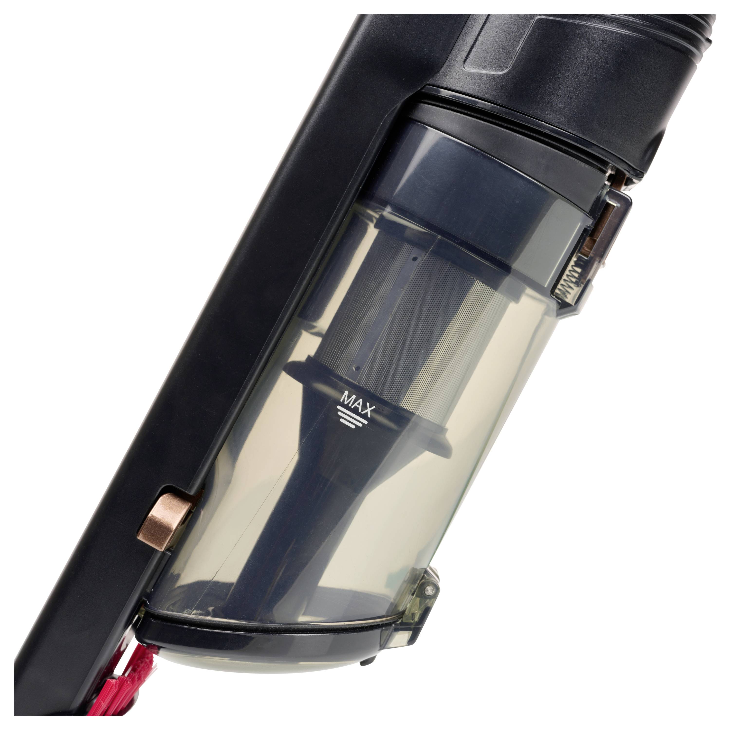 Gros plan du bac à poussière d'un balai aspirateur et de la chambre cyclonique avec une ligne de remplissage « MAX » visible et un loquet de dégagement.