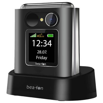 Un téléphone mobile bea-fon sur un socle de recharge, affichant 12:34, 28.07., vendredi, avec les icônes 4G LTE et batterie sur l'écran.