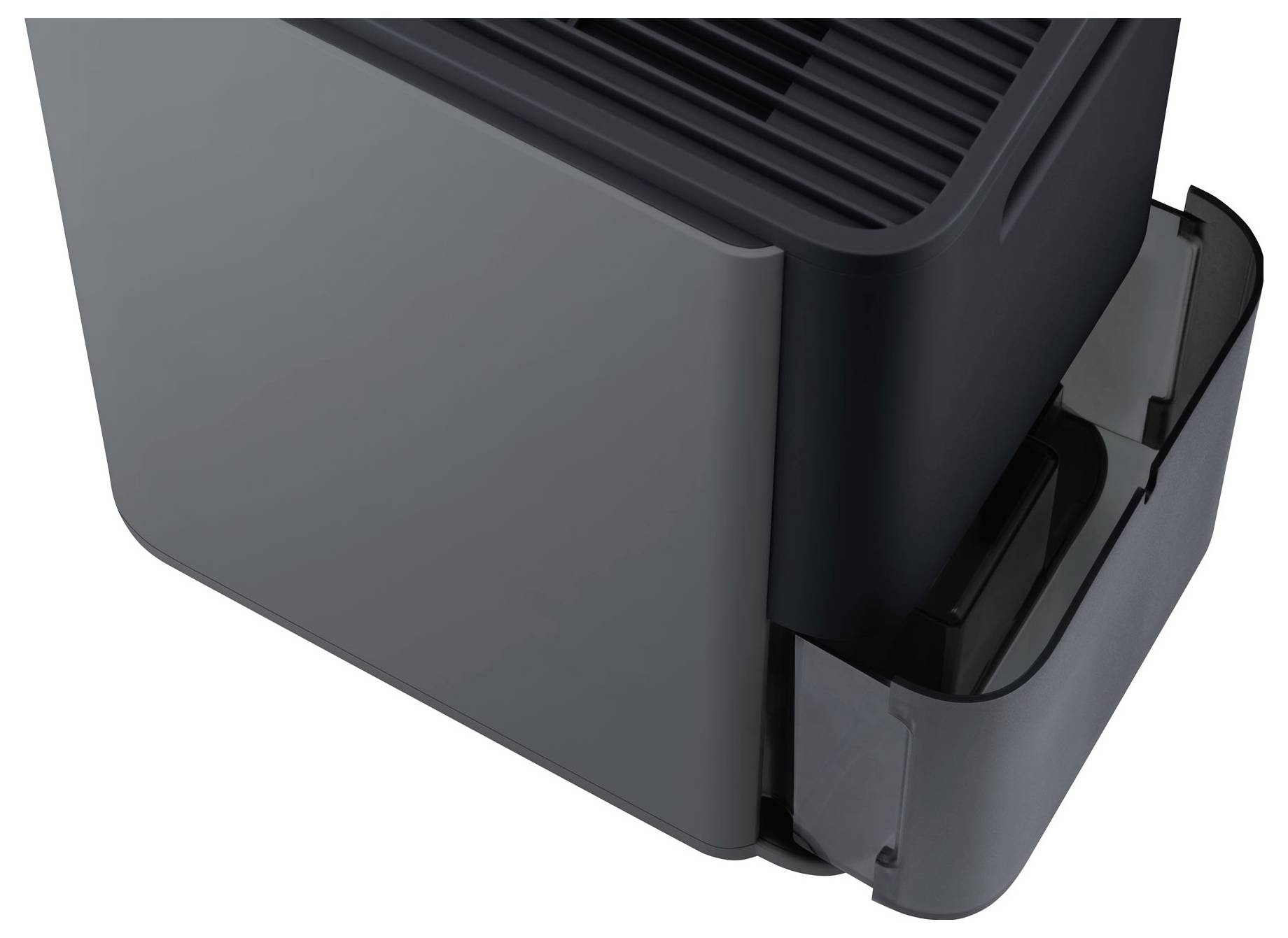 Gros plan d'un coin de dispositif électronique en plastique noir avec un sommet aéré et un compartiment latéral ou socle d'accueil attaché.