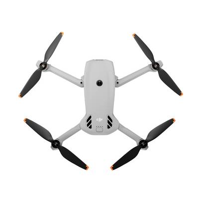 Vue de dessus d'un drone quadricoptère DJI blanc avec quatre hélices sur un fond uni.