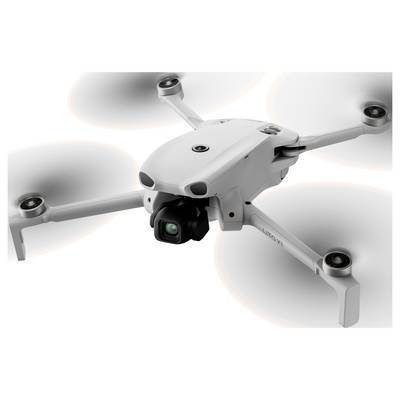 Un drone quadcoptère blanc avec un cardan de caméra et quatre hélices rotatives, présenté sur un fond clair uni.