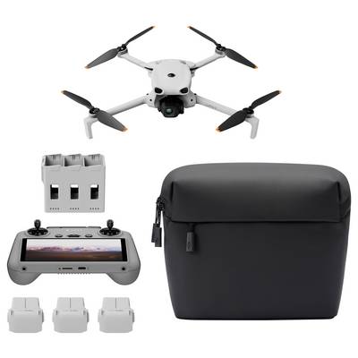 Kit de drone avec quadcoptère blanc, télécommande, batterie supplémentaire, trois housses de batterie et un étui de transport noir sur fond blanc.